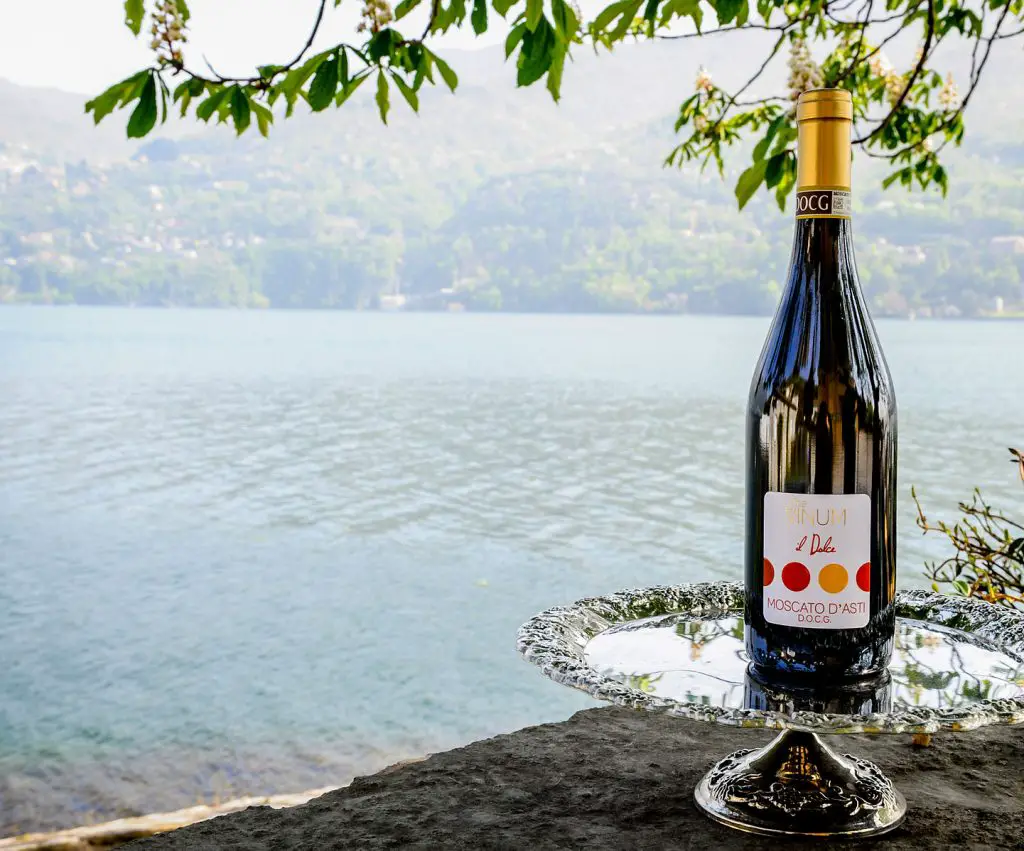 Bottle of Moscato d'Asti by a river or sea bank