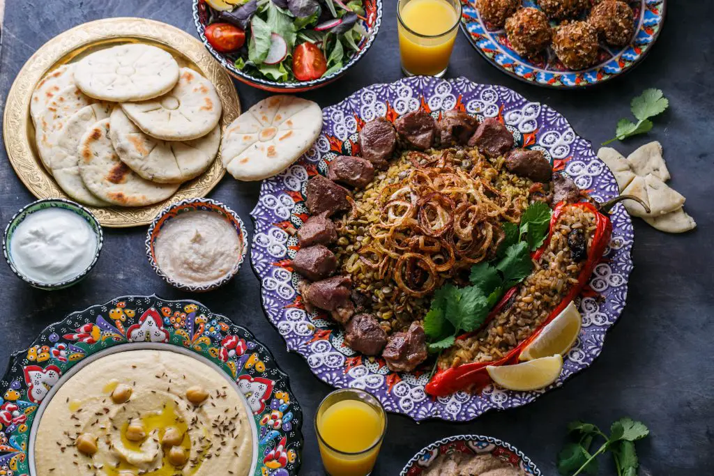 Middle Eastern Food hummus, pita, kofta, salads top view