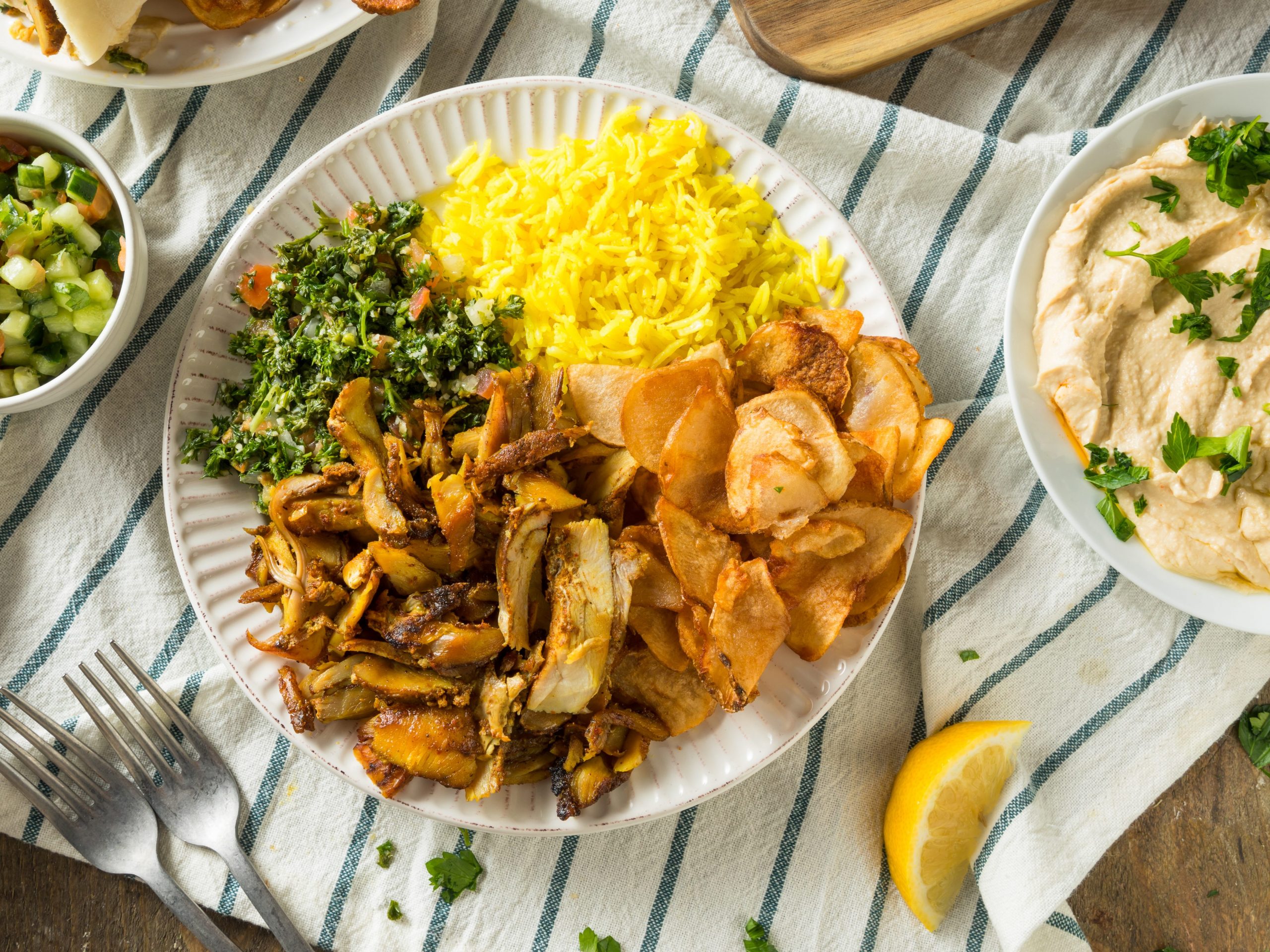 Homemade Chicken Shawarma with race and salad on a plate