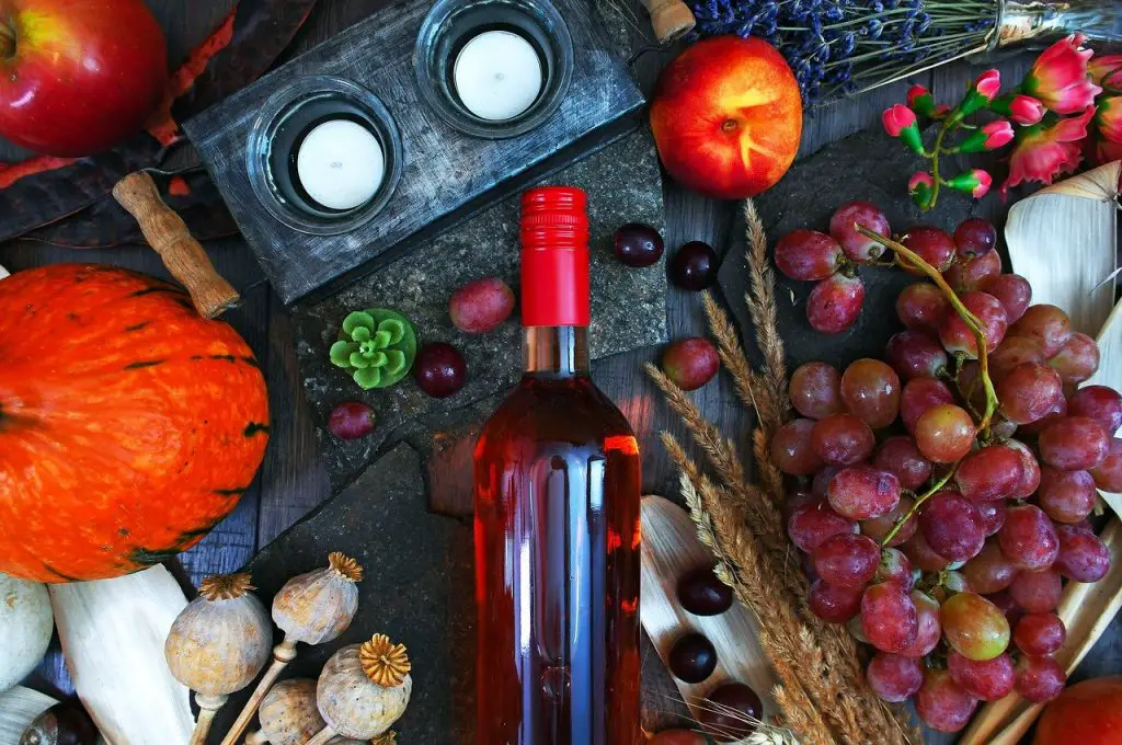 Moscato Rosa rose bottle on table with grapes