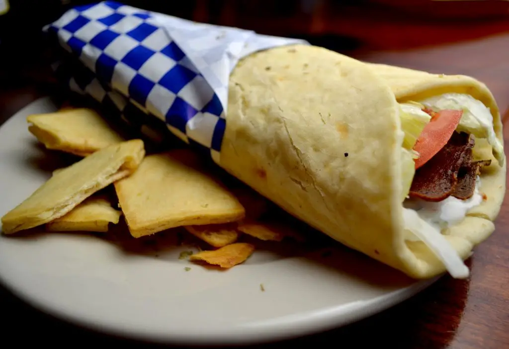 gyros wrap on plate with blue greek flag wrapping